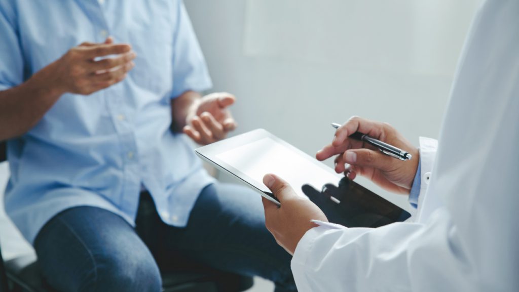 Doctor reviewing clinical research information with a patient